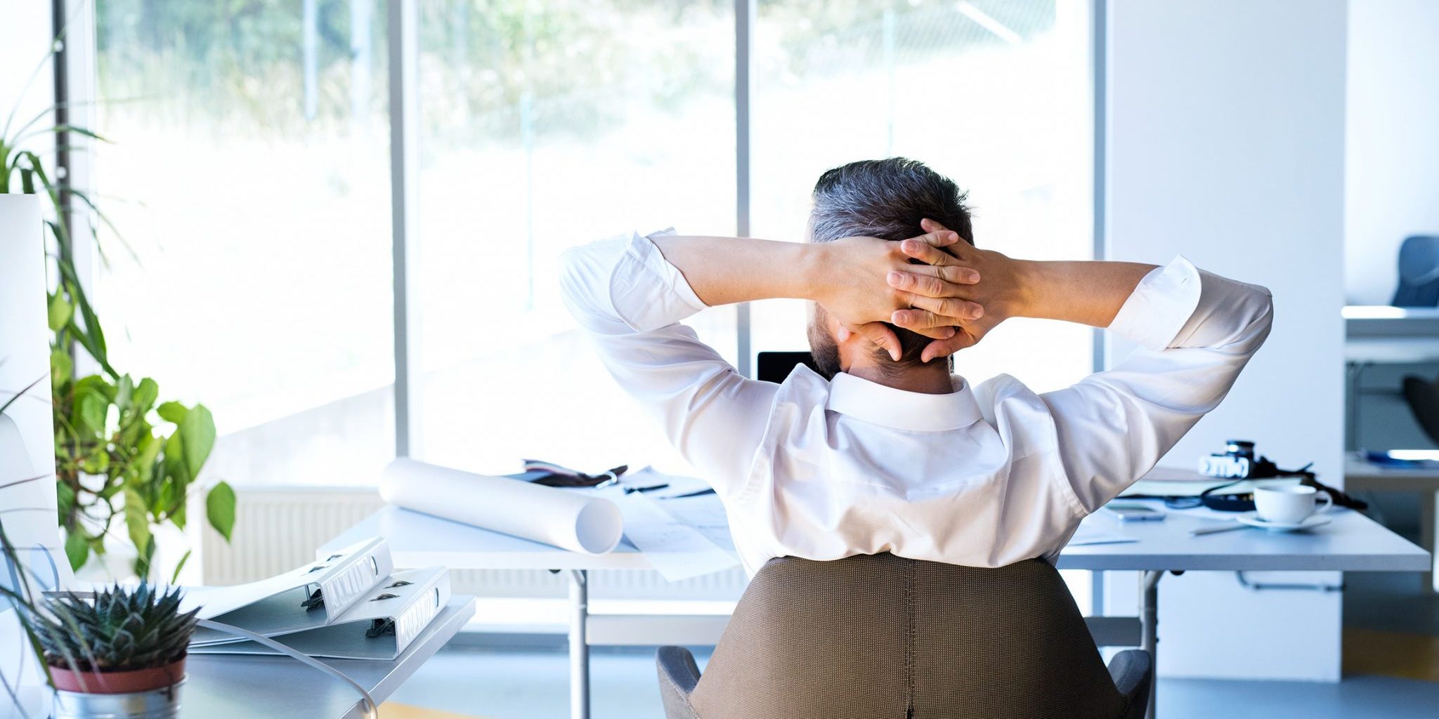 Businessman at the desk in his office resting.